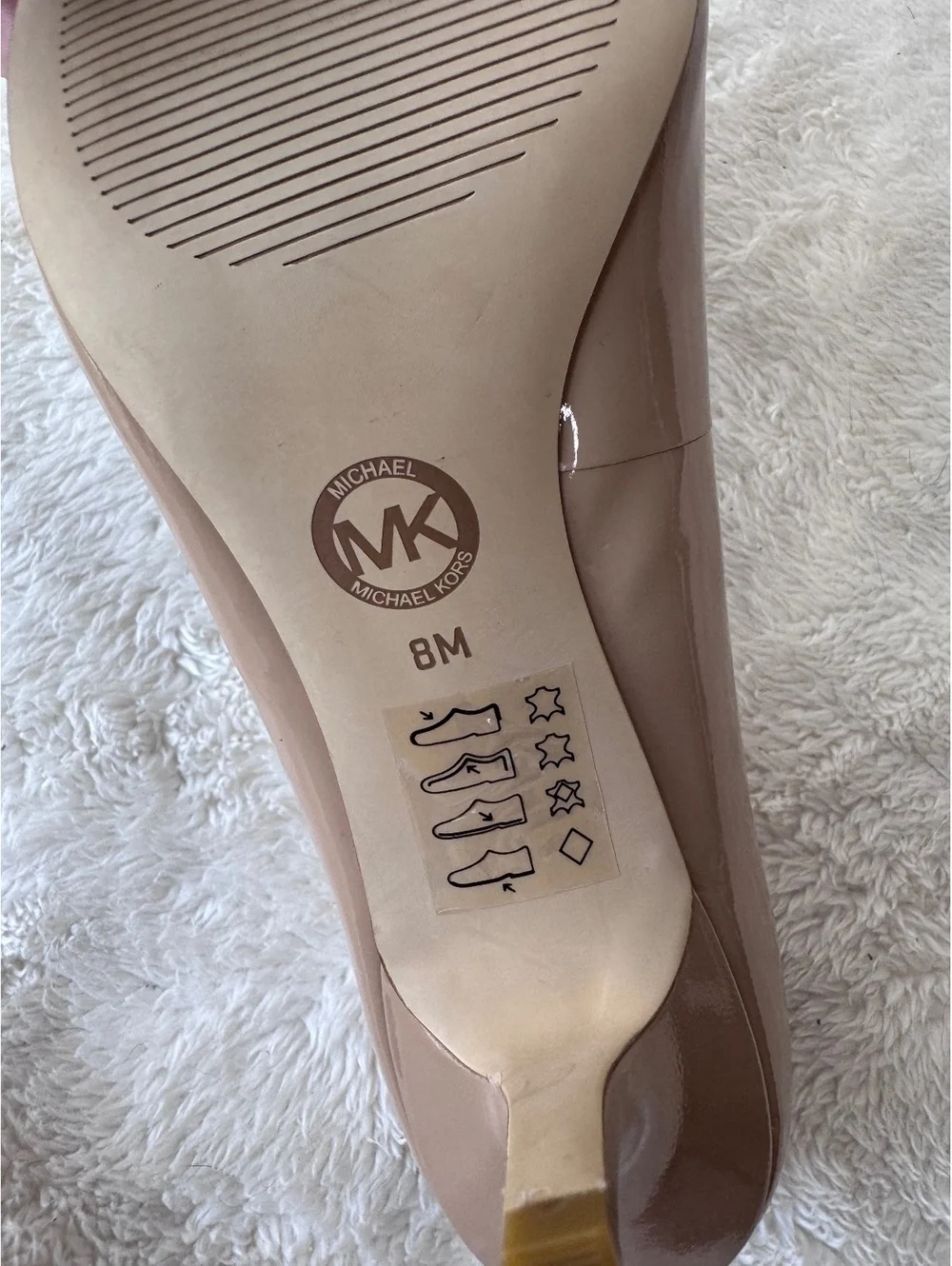 Michael Kors women’s patent leather peep-toe pumps in a classic nude/blush color